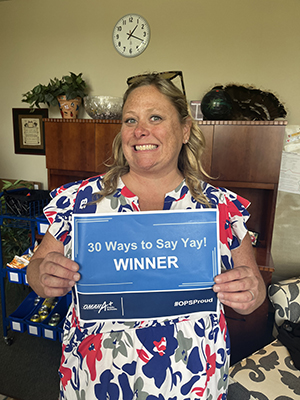 A staff member shows off an award